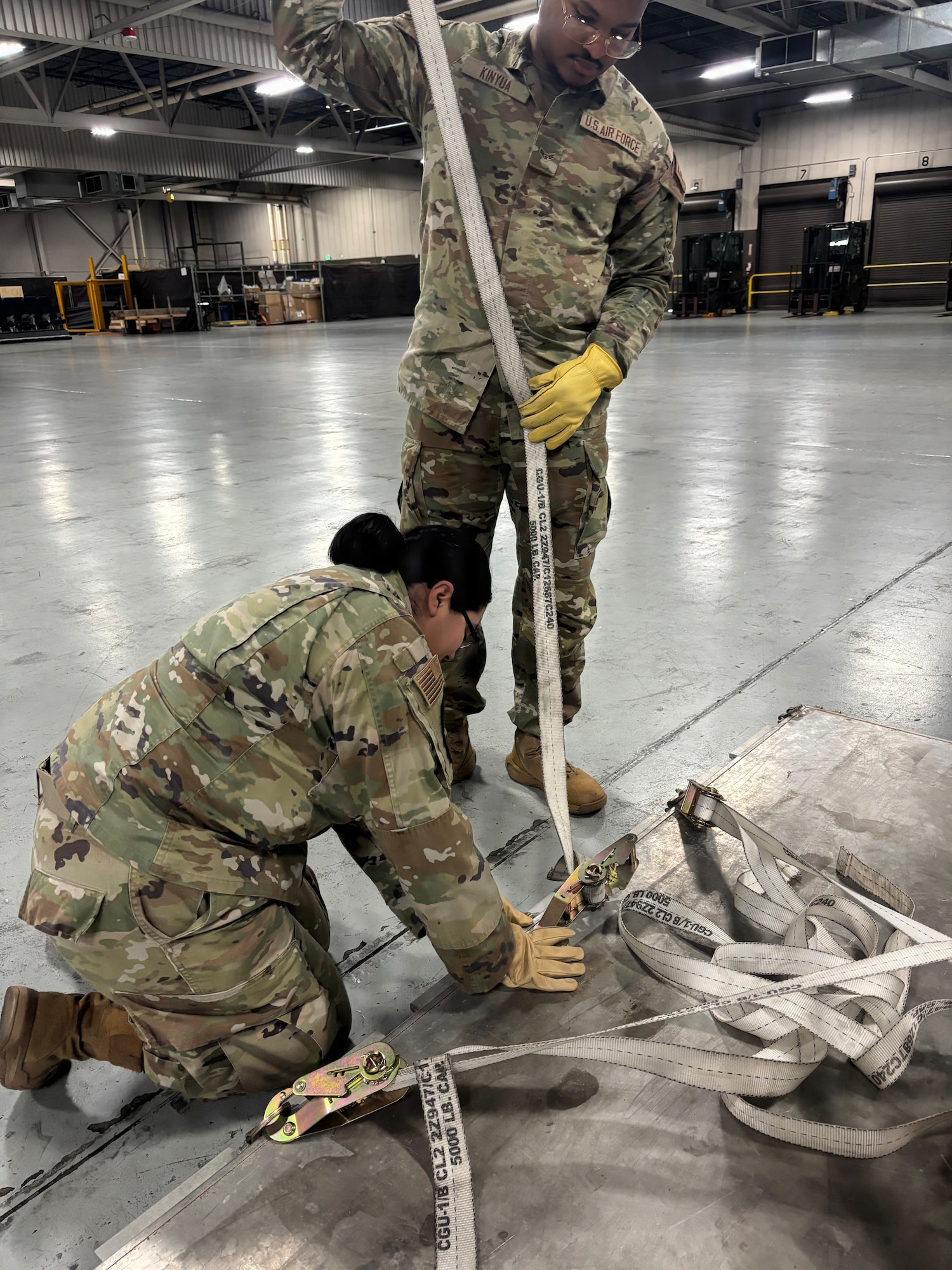 U.S. Senior Airman Esmeralda Leathem, 62d Comptroller Squadron financial analysis technician, left, and Airman 1st Class Wikiah Kinyua, 62d CPTS financial operations technician, prepare to secure a safe to a pallet at Joint Base Lewis-McChord, Washington, January 22, 2026.