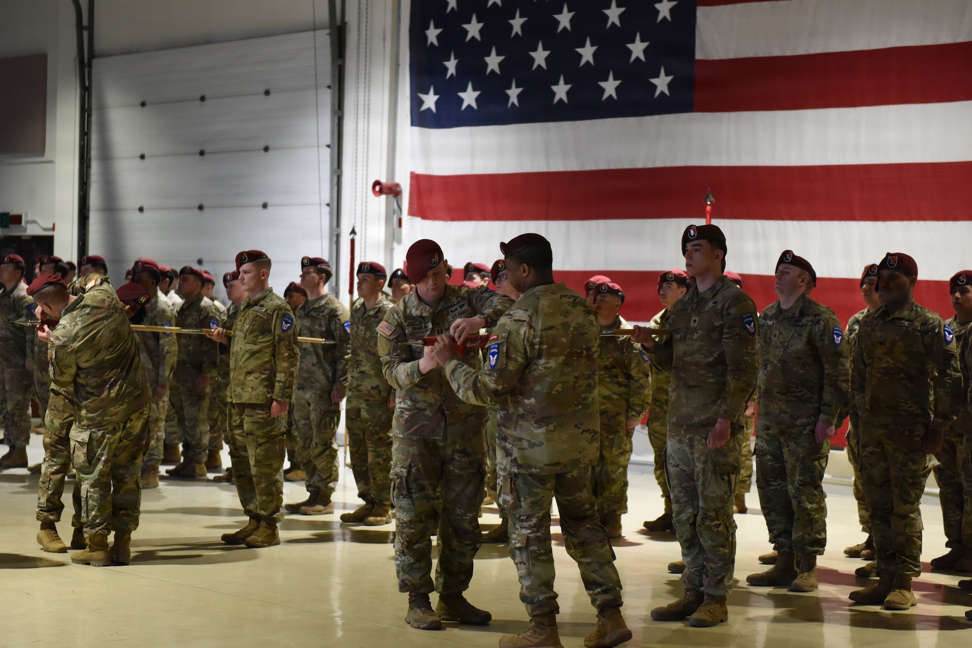 U.S. Army Soldiers assigned with 6th Brigade Engineer Battalion, 2nd Infantry Brigade Combat Team (Airborne), 11th Airborne Division, case their old colors during a reflagging ceremony at the Alaska National Guard Armory, April 17, 2026, on Joint Base Elmendorf-Richardson, Alaska. The 6th BEB officially reflagged as the 6th Division Engineer Battalion, marking a significant step in transforming and strengthening the 11th Airborne Division mission in the arctic and Indo-Pacific. (U.S. Air Force photo by Nicholas Holland)