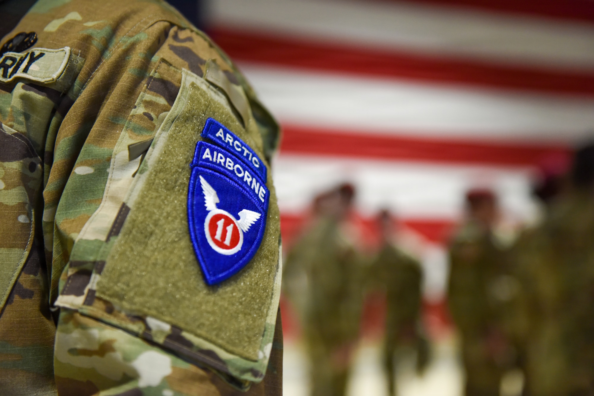 A 11th Airborne Division identifier patch is displayed on a uniform during a reflagging ceremony at the Alaska National Guard Armory, April 17, 2026, on Joint Base Elmendorf-Richardson, Alaska. The 6th BEB officially reflagged as the 6th Division Engineer Battalion, marking a significant step in transforming and strengthening the 11th Airborne Division mission in the arctic and Indo-Pacific. (U.S. Air Force photo by Nicholas Holland)