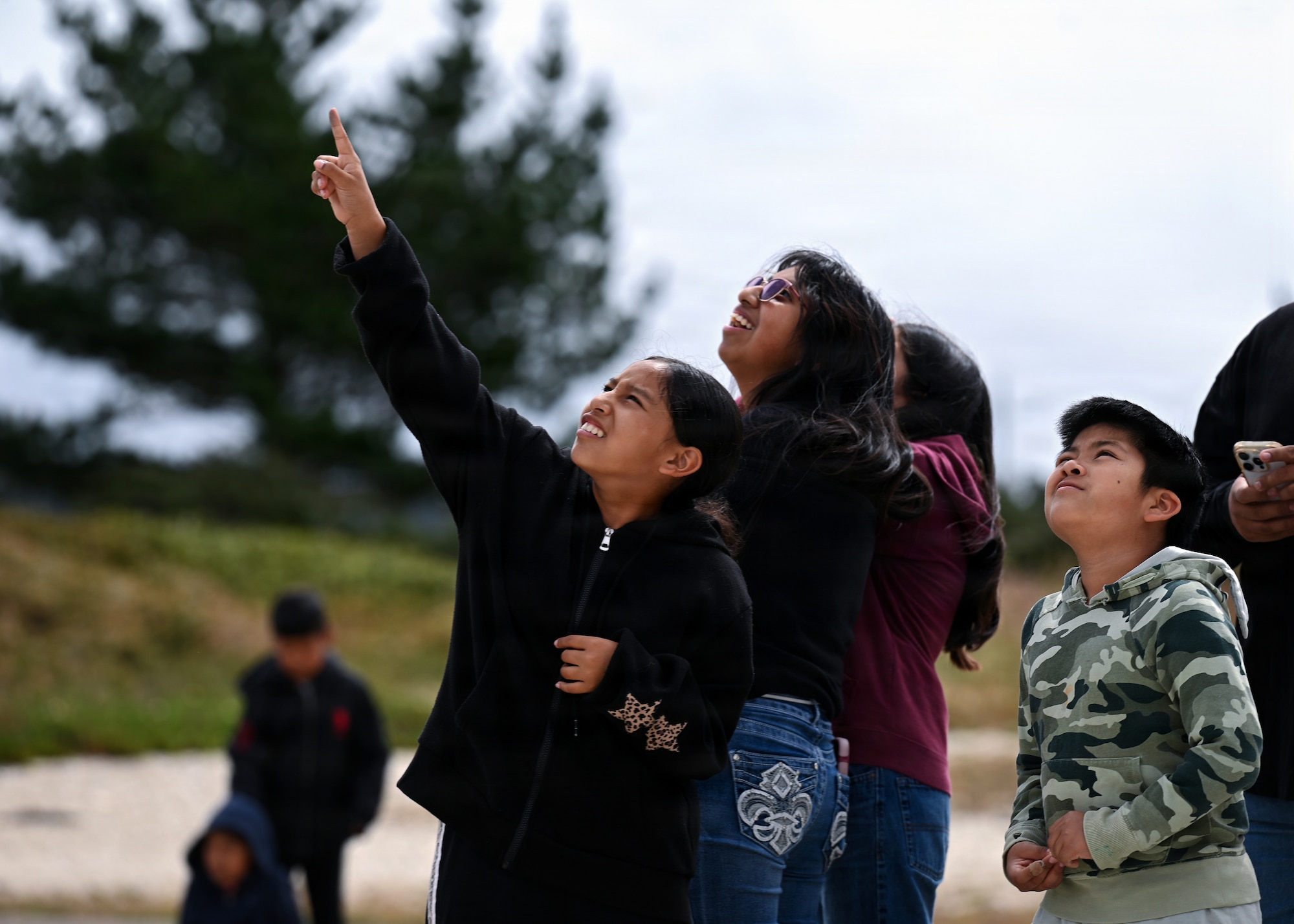 Boys and Girls look up toward the sky.