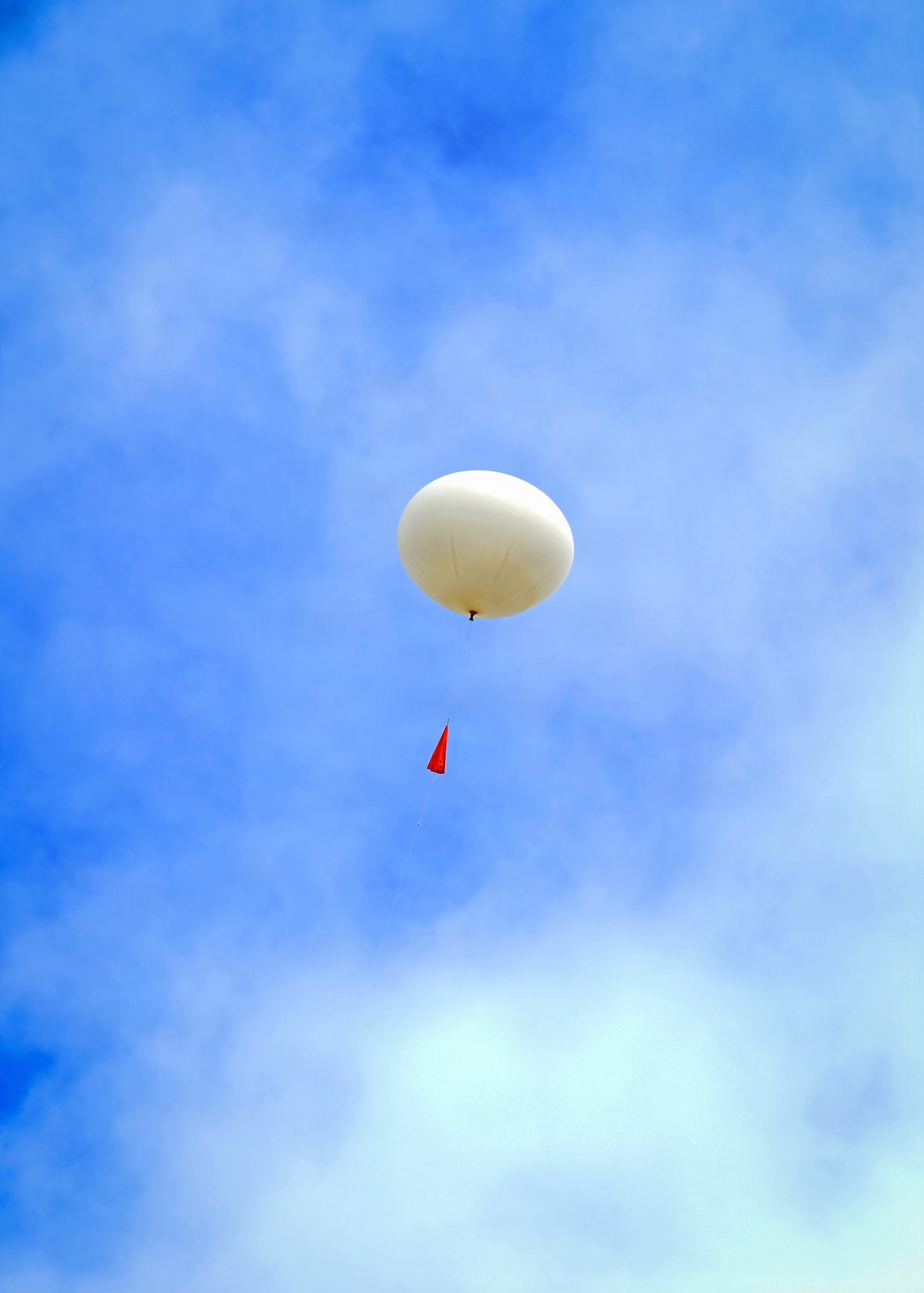 A weather balloon ascends into the sky