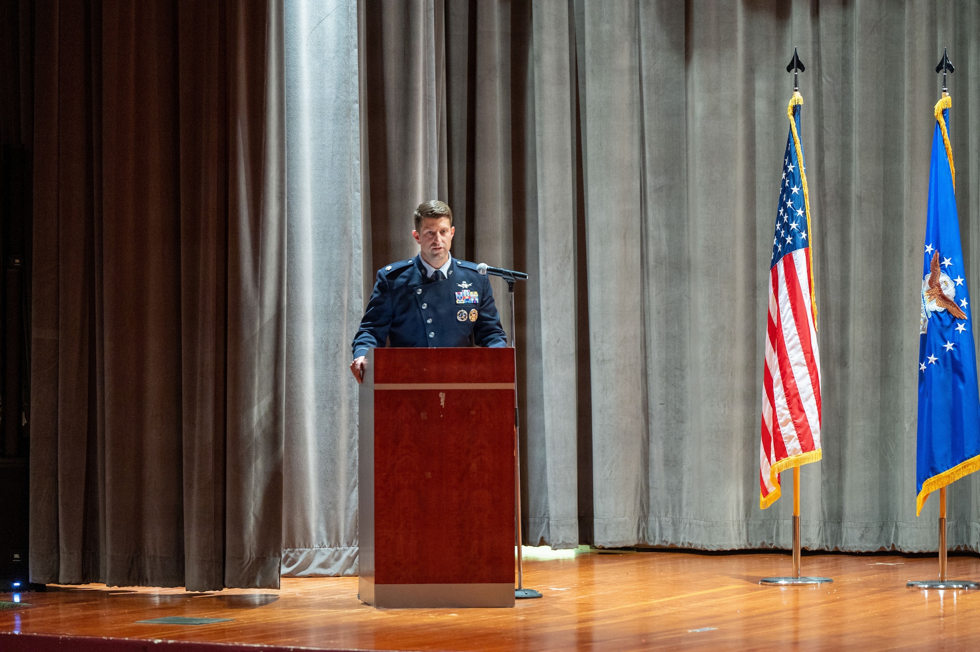 A man stands behind a podium and speaks