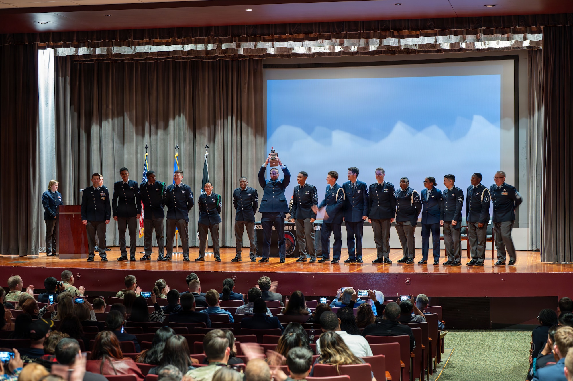A group of students line up on a stage
