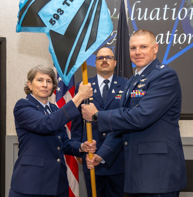 Lt. Col. David Heinz, commander of the 593rd Test and Evaluation Squadron, accepts the squadron guidon, assuming command, from Col. Sacha N. Tomlinson, Space Delta 12 commander, during the 593rd TES during the activation ceremony April 20, 2026, at Edwards Air Force Base, California. (U.S. Air Force photo by Daniel Kelley, 412th Test Wing Public Affairs)