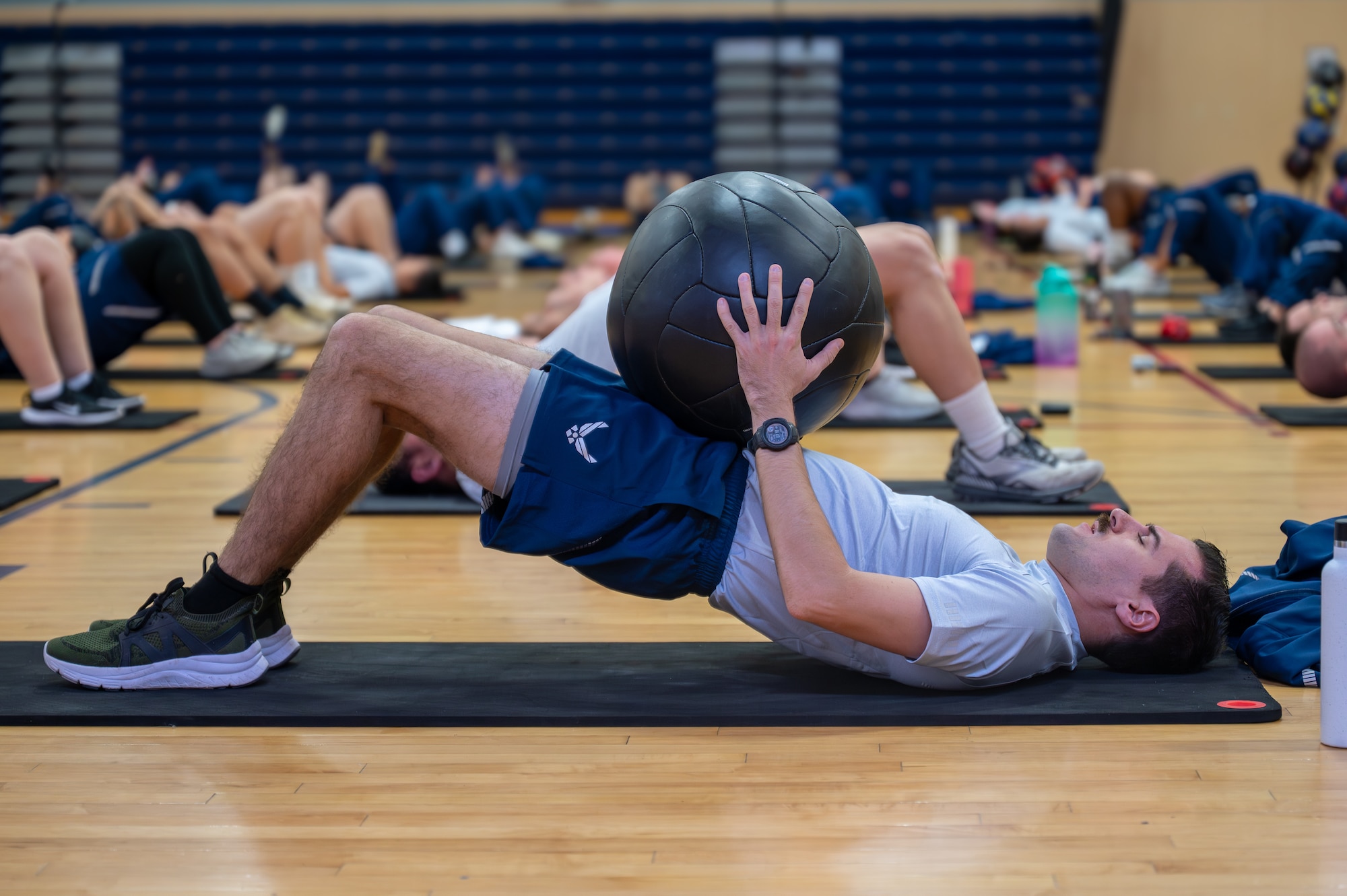 A man exercises with a weighted ball.