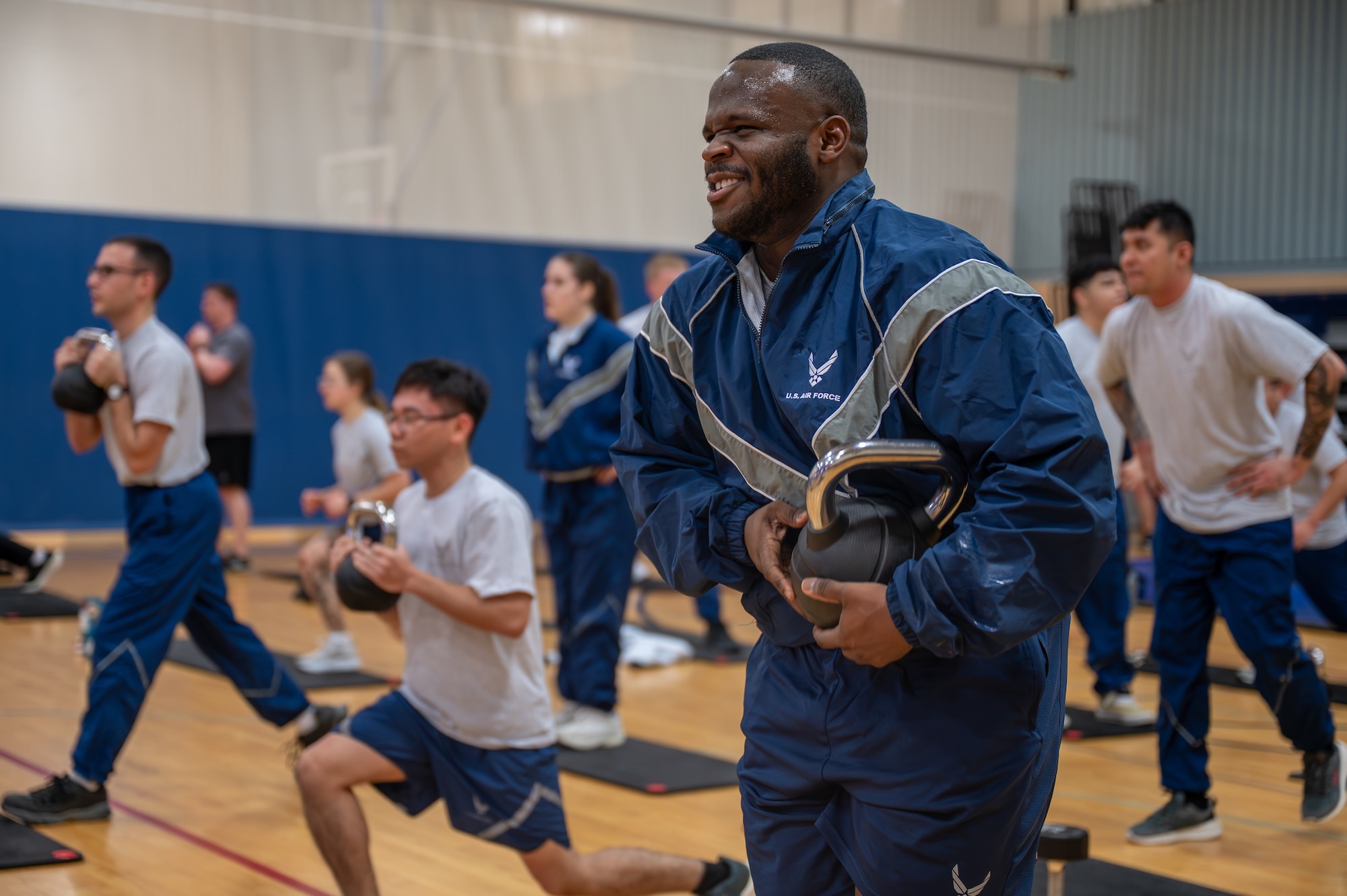 A man exercises with a kettle bell.