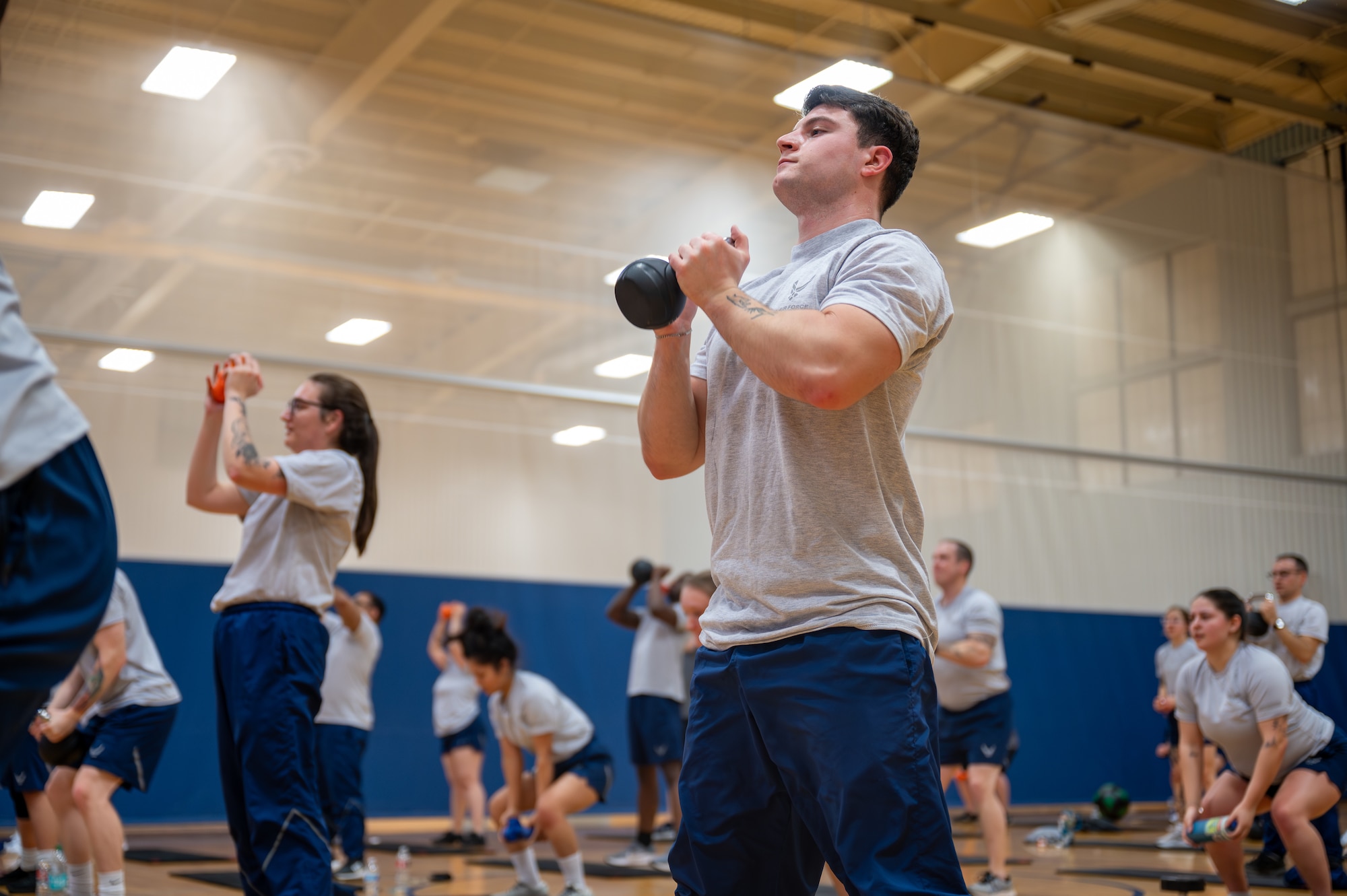 A man exercises with a kettle bell.