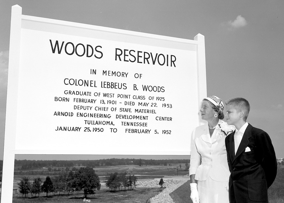 Dorothy Woods, wife of the late Col. Lebbeus Woods, and their son Lebbeus Woods, look at the sign unveiled during the July 1, 1953, ceremony to dedicate the Arnold Engineering Development Center Lake as Woods Reservoir in honor of Col. Woods. Col. Woods, Deputy Chief of Staff of AEDC Materiel, was assigned to AEDC from January 1950 to February 1952. He was one of the first two Air Force officers to come to Tennessee in connection with the AEDC project in the early 1950s. He passed away in May 1953. (U.S. Air Force photo)