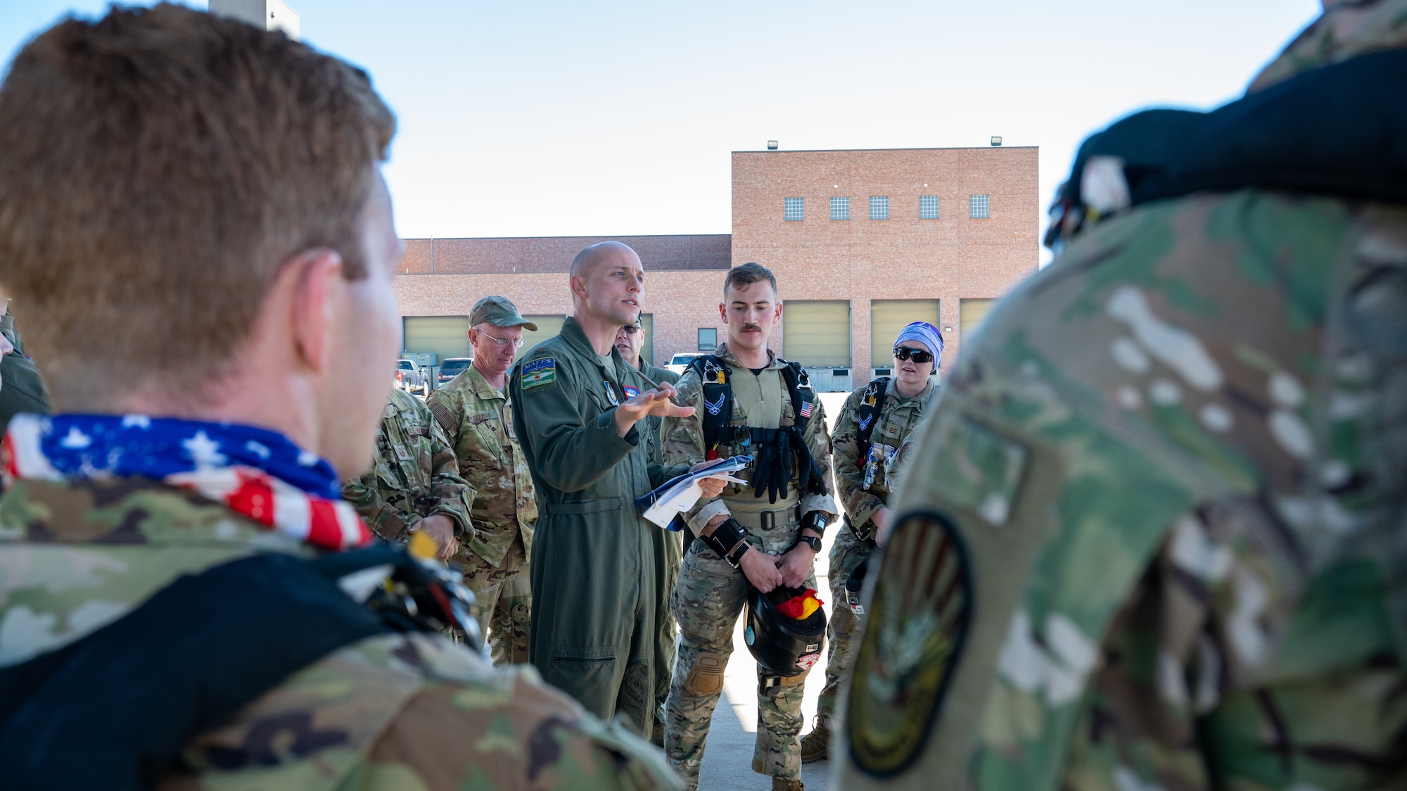 A U.S. Air Force major speaks to a group of cadets about safety before a planned parachute jump from a C-130H Hercules aircraft.