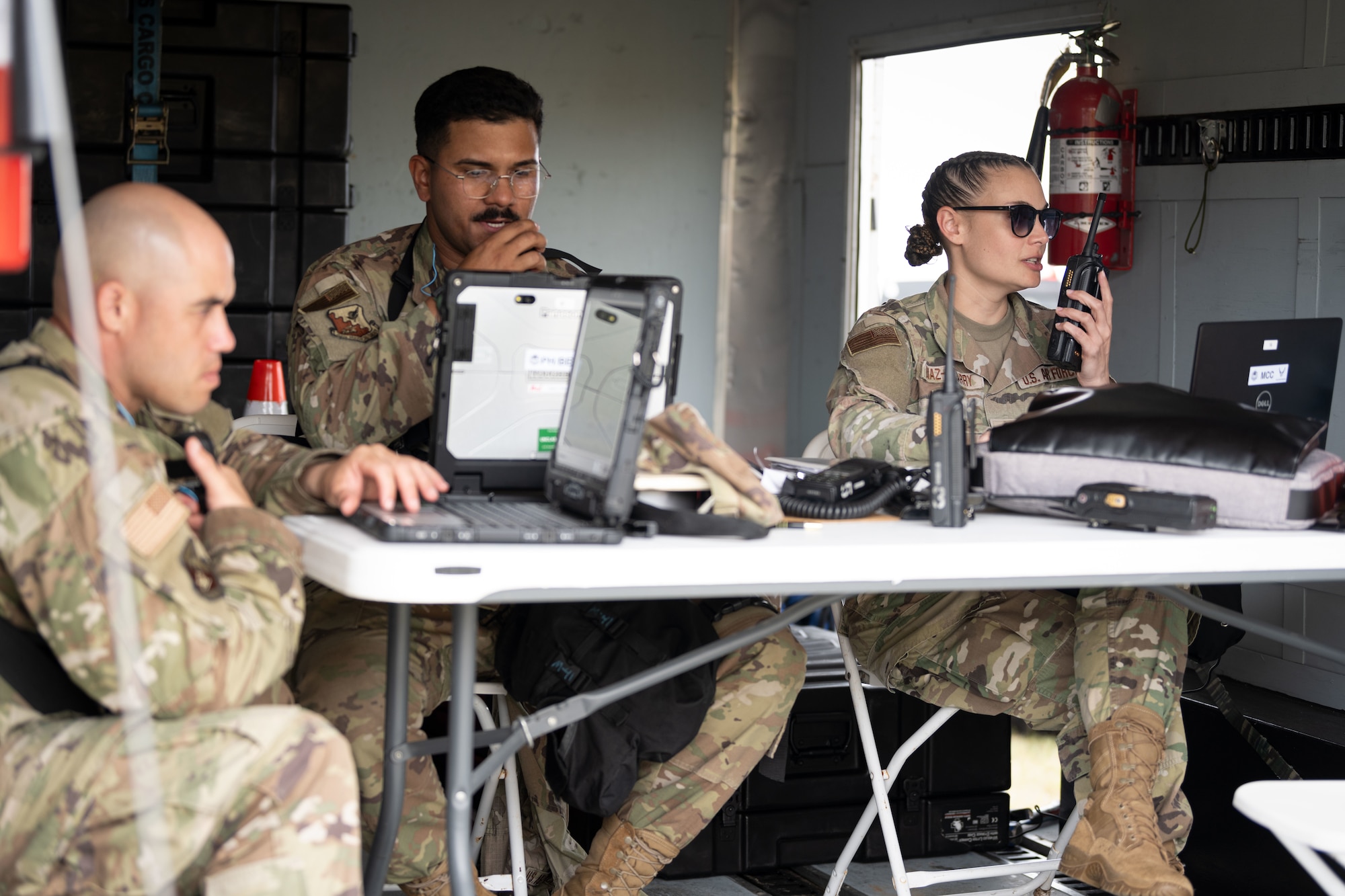U.S. Air Force Senior Airman Jose Ortiz, public health technician and Capt. Sandra Diaz, medical plans officer, both with 156th Medical Group, Detachment 1, Puerto Rico Air National Guard, operate the medical command center during a Synchronization Collective Training exercise at Camp Santiago Joint Training Center, Salinas, Puerto Rico, March 12, 2026. The exercise immersed teams in high-stress disaster simulations involving search and extraction, decontamination, and medical triage focused on ensuring readiness during domestic operations and future evaluations. (U.S. Air National Guard photo by Master Sgt. Rafael Rosa)