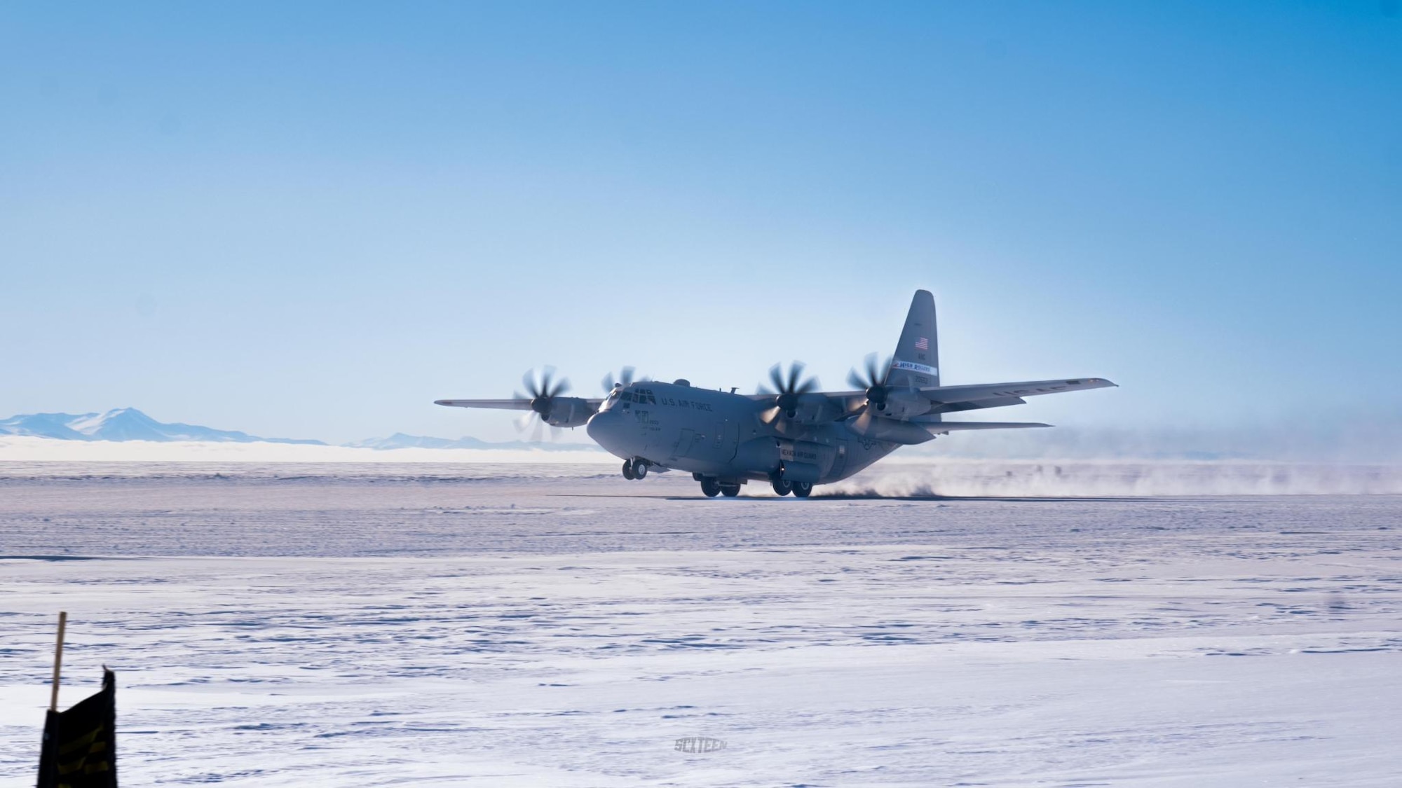 A C-130 plane taking off from an ice runway.