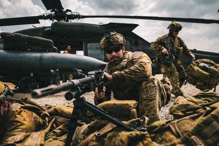 An Australian Army soldier, assigned to Charlie Company, 5th/7thBattalion, Royal Australian 
Regiment, 1st Brigade, provides area security while his fellow soldiers exit a U.S. Army UH-60 Black Hawk helicopter during U.S. Army led cold-load training as part of Exercise Balikatan 2026 at Cagayan North International Airport, Lal-lo, Philippines, April 21, 202
