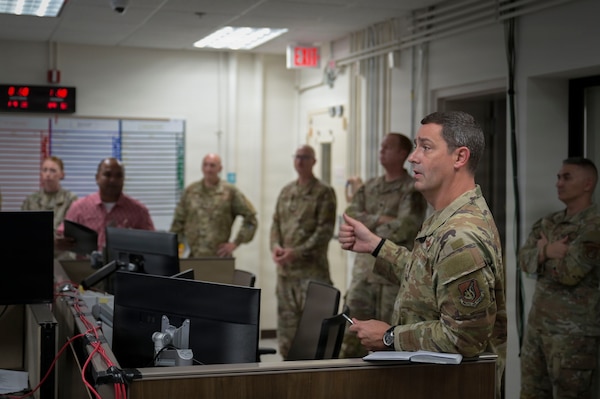 Brig. Gen. Dan Cooley, 36th Wing commander, confers with Crisis Action Team members during Typhoon Sinlaku recovery response operations at Andersen Air Force Base, Guam. The team transitioned from a scheduled exercise to real-world operations, enabling immediate support to Defense Support of Civil Authorities efforts.