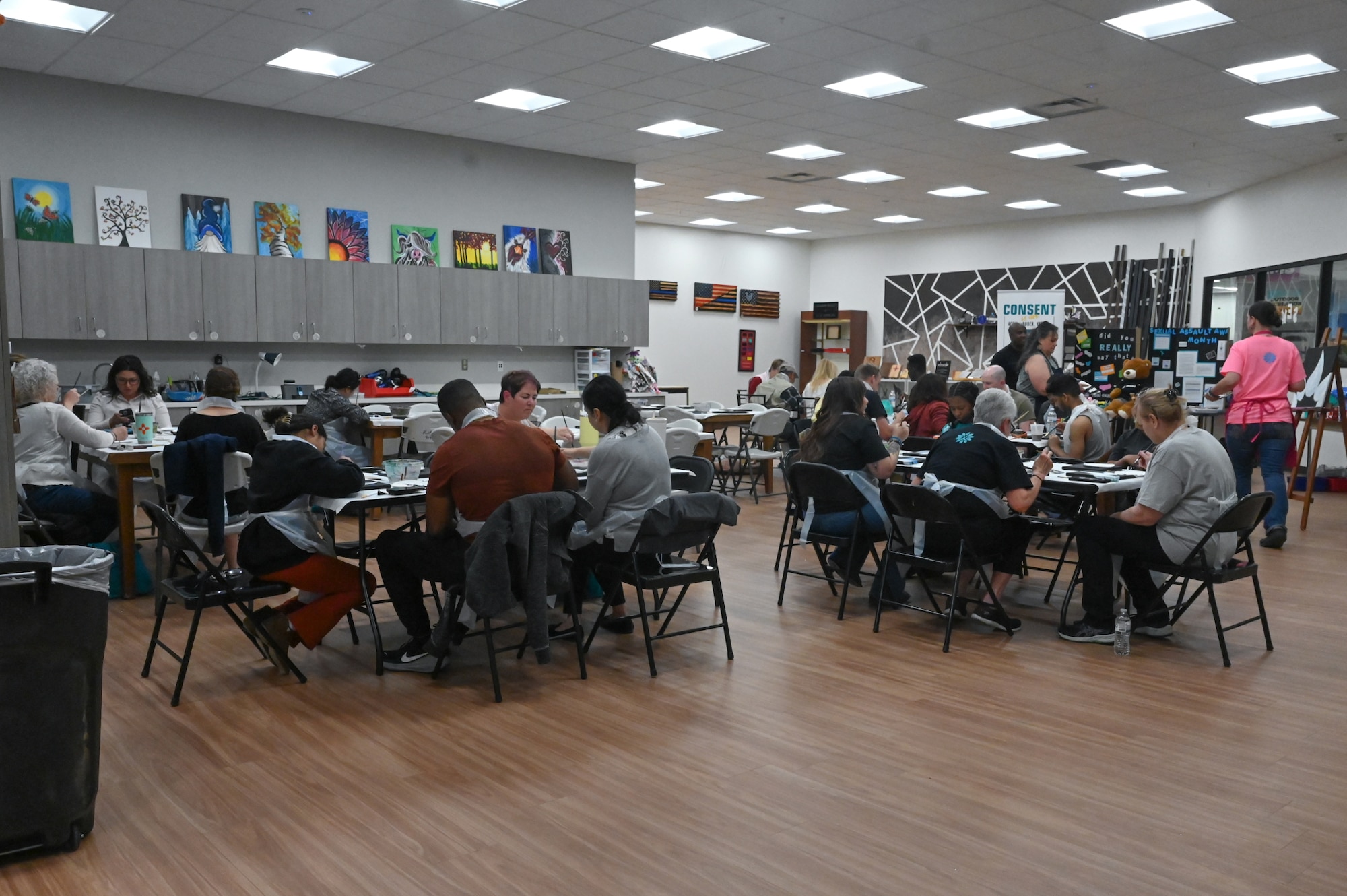 Members of Team Kirtland participate in a Sexual Assault Prevention and Response (SAPR) Paint Night at Kirtland Air Force Base, New Mexico, April 16, 2026. The event, held in observance of Sexual Assault Awareness and Prevention Month (SAAPM), provided Airmen and Guardians a creative outlet to express solidarity and reinforce a collective commitment to a safe and respectful workplace. By combining advocacy with art, the SAPR team provides unique avenues for education, ensuring every member of the Kirtland community understands their role in preventing harm and protecting the force. (U.S. Air Force Photo by Airman Maurice Casilla)