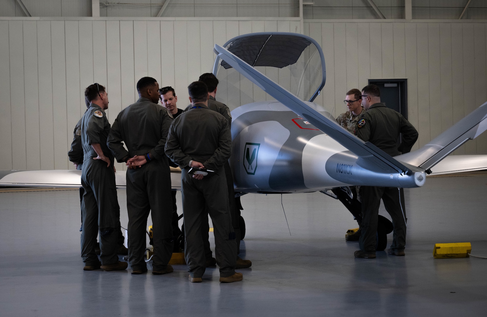 U.S. Airmen gather around a drone during Exercise Ready Tiger 26-3 at Savannah Air National Guard Base, Georgia