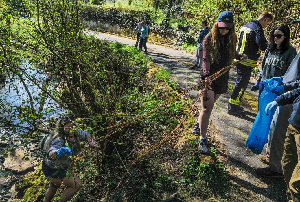 Volunteers untangle an abandoned rope from brush along the Spangerbach creek during the annual creek cleanup in Spangdahlem, Germany, April 25, 2026. The event drew participation from across the community, including members of the village youth fire department and U.S. Air Force Noncommissioned Officer Academy students. (U.S. Air Force photo by Master Sgt. Alexander W. Riedel)