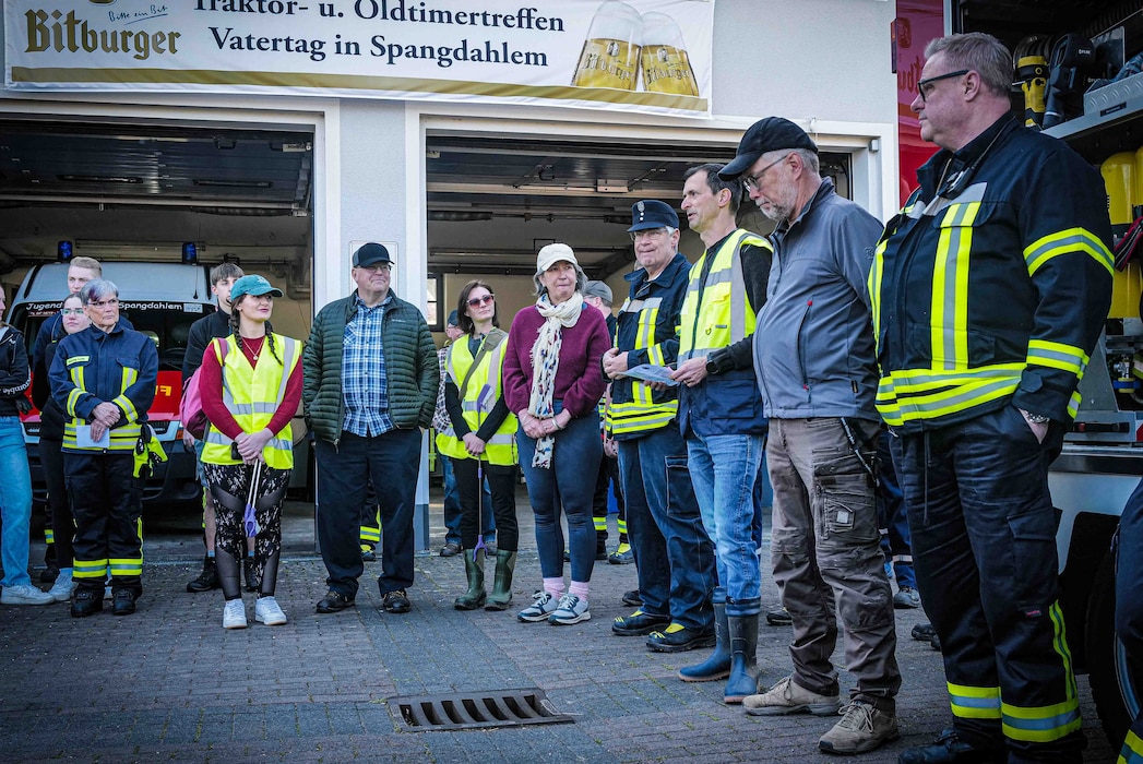 Christian Thurner, third from right, of the 52nd Civil Engineer Squadron's environmental office, and Spangdahlem Mayor Alois Gerten, to his right, address volunteers at the Spangdahlem volunteer fire department during the opening of the annual Spangerbach creek cleanup in Spangdahlem, Germany, April 25, 2026. The cleanup began in 1999 and has taken place annually, with the exception of one year during the COVID-19 pandemic. (U.S. Air Force photo by Master Sgt. Alexander W. Riedel)