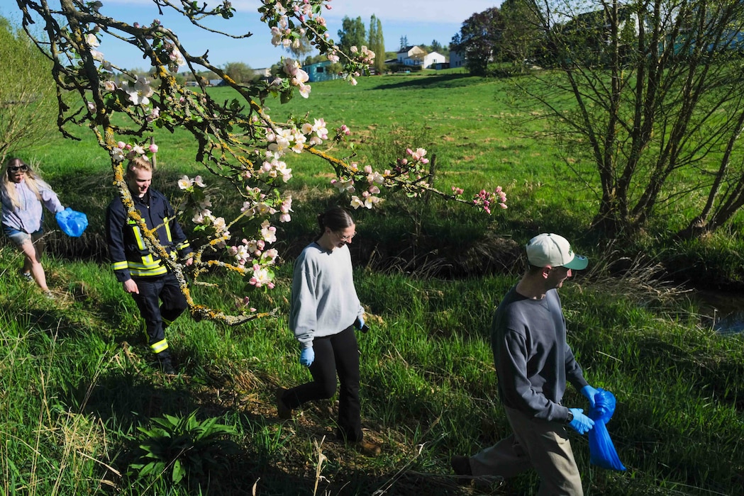 Volunteers walk along the Spangerbach creek during the annual creek cleanup in Spangdahlem, Germany, April 25, 2026. The Spangerbach runs between the historic halves of the village, the former settlements of Spang and Dahlem, which merged into a single municipality in 1969. (U.S. Air Force photo by Master Sgt. Alexander W. Riedel)