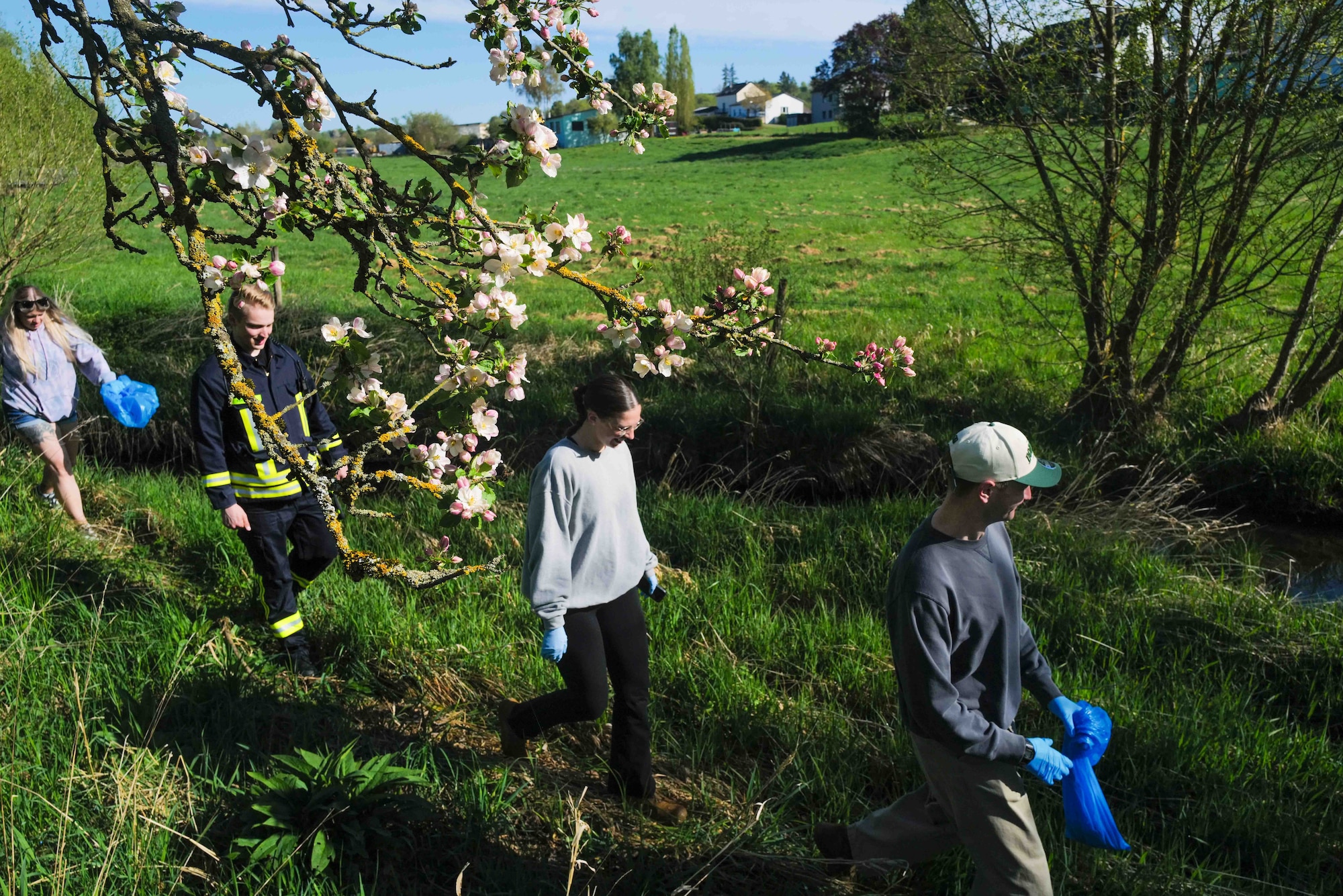 Volunteers walk along the Spangerbach creek during the annual creek cleanup in Spangdahlem, Germany, April 25, 2026. The Spangerbach runs between the historic halves of the village, the former settlements of Spang and Dahlem, which merged into a single municipality in 1969. (U.S. Air Force photo by Master Sgt. Alexander W. Riedel)