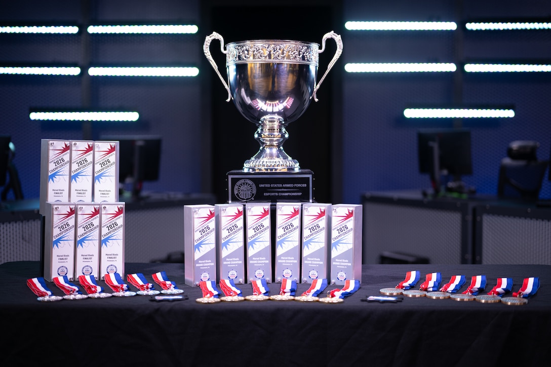 The championship trophy and awards are displayed on stage before the 2026 Armed Forces Esports Championship at Localhost in Philadelphia, Pennsylvania, April 25, 2026. Service members competed in organized esports competition playing Marvel Rivals for championship honors while representing their respective services. Armed Forces Sports brings together service members from the Army, Marine Corps, Navy, Coast Guard, and Air Force, and Space Force to compete at the national level. Armed Forces Sports promotes physical fitness, cognitive readiness, teamwork, and competitive opportunities for military members while supporting recruitment and retention efforts and strengthening partnerships through emerging sports platforms. (DoW photo by U.S. Marine Corps Sgt. Kayla Halloran)Service members competed in organized esports competition playing Marvel Rivals for championship honors while representing their respective services. Armed Forces Sports brings together service members from the Army, Marine Corps, Navy, Coast Guard, and Air Force, and Space Force to compete at the national level. Armed Forces Sports promotes physical fitness, cognitive readiness, teamwork, and competitive opportunities for military members while supporting recruitment and retention efforts and strengthening partnerships through emerging sports platforms. (DoW photo by U.S. Marine Corps Sgt. Kayla Halloran)