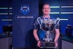 U.S. Air Force Major Chad Speer, from Wasilla, Alaska, poses with a championship trophy after winning the 2026 Armed Forces Esports Championship at Localhost in Philadelphia Pennsylvania, April 25, 2026. Service members competed in organized esports competition playing Marvel Rivals for championship honors while representing their respective services. Armed Forces Sports brings together service members from the Army, Marine Corps, Navy, Coast Guard, Air Force, and Space Force to compete at the national level. Armed Forces Sports promotes physical fitness, cognitive readiness, teamwork, and competitive opportunities for military members while supporting recruitment and retention efforts and strengthening partnerships through emerging sports platforms. (DoW photo by U.S. Navy Mass Communication Specialist 2nd Class Christopher Suarez)
