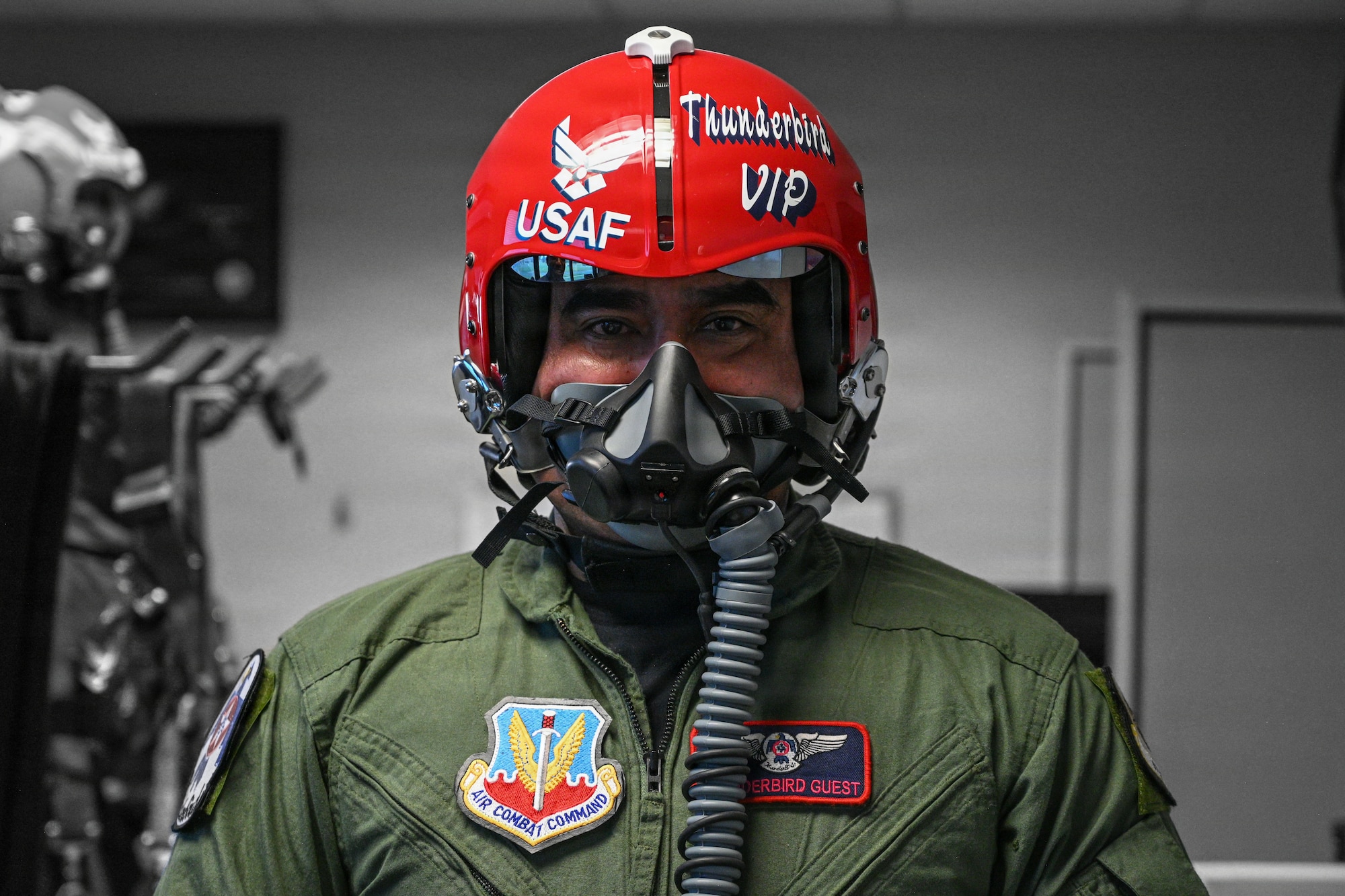 A man poses for a photo in a jet helmet.