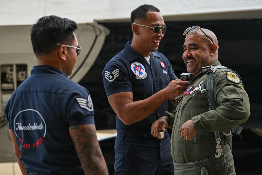 A man gets situated in a flight suit.