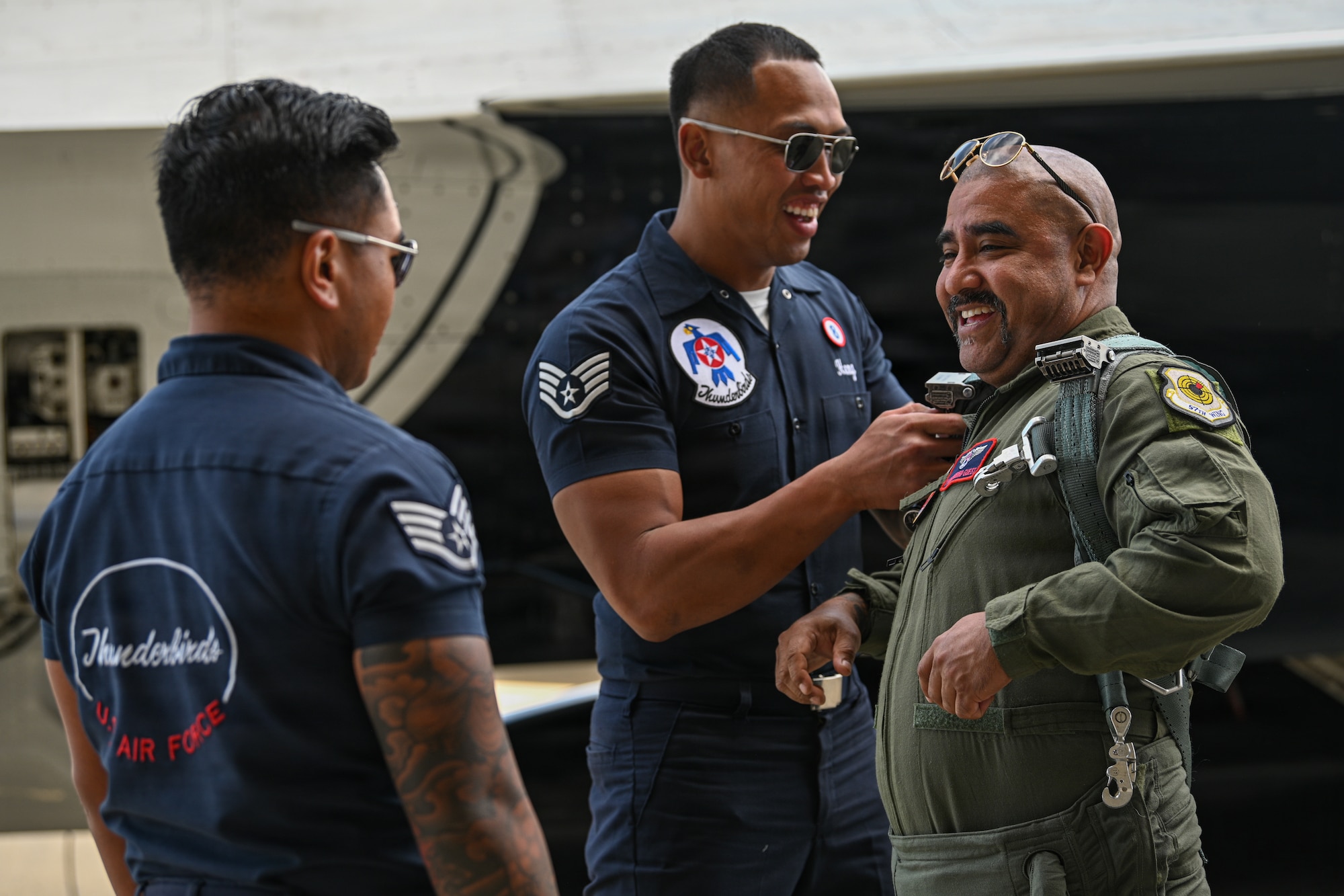 A man gets situated in a flight suit.
