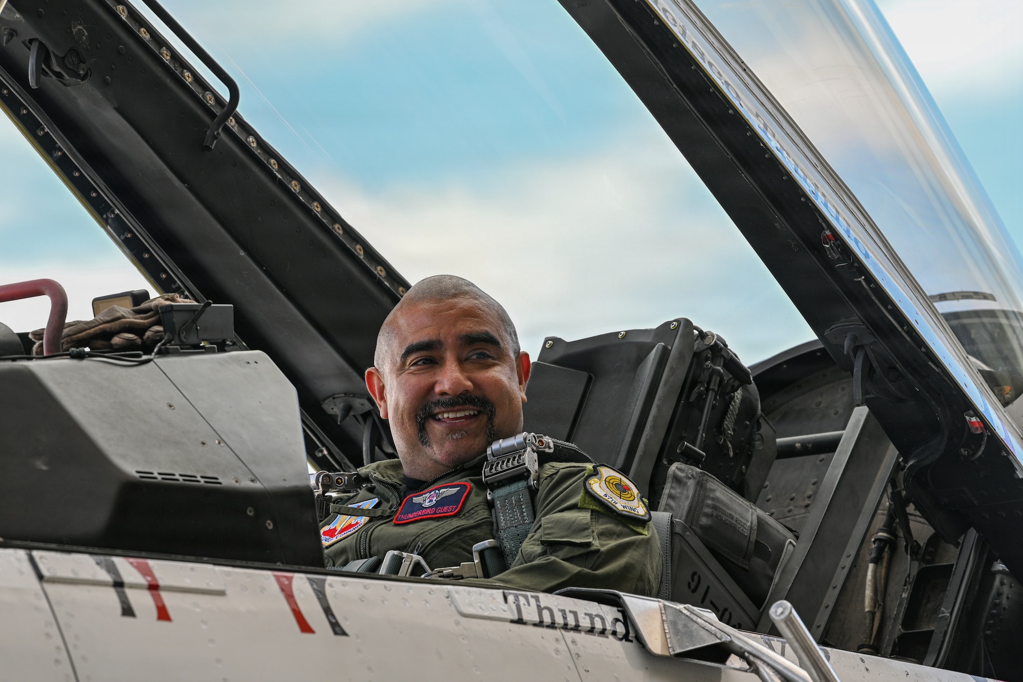 A man sitting in the cockpit of a jet.