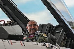 A man sitting in the cockpit of a jet.