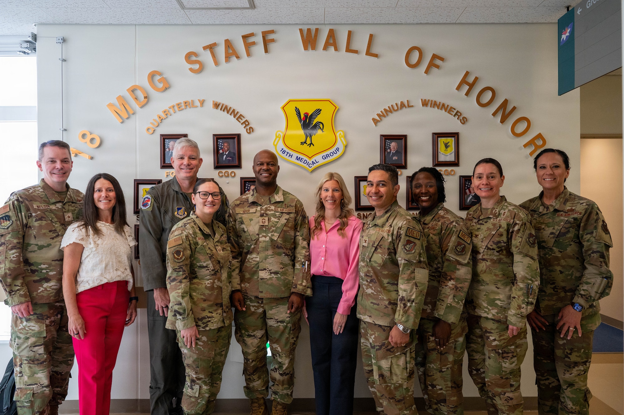 Service members and civilians pose for photo.