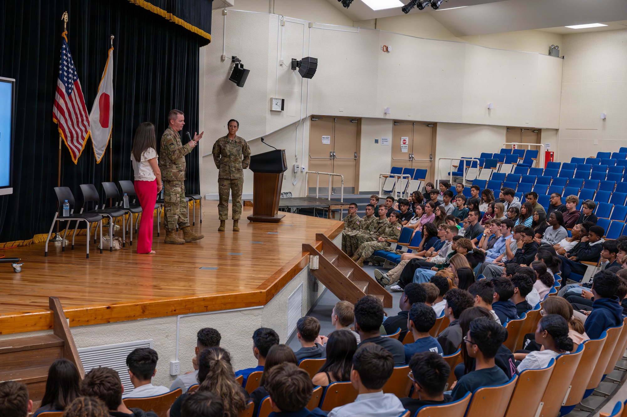 Service members and civilian gives a speech.