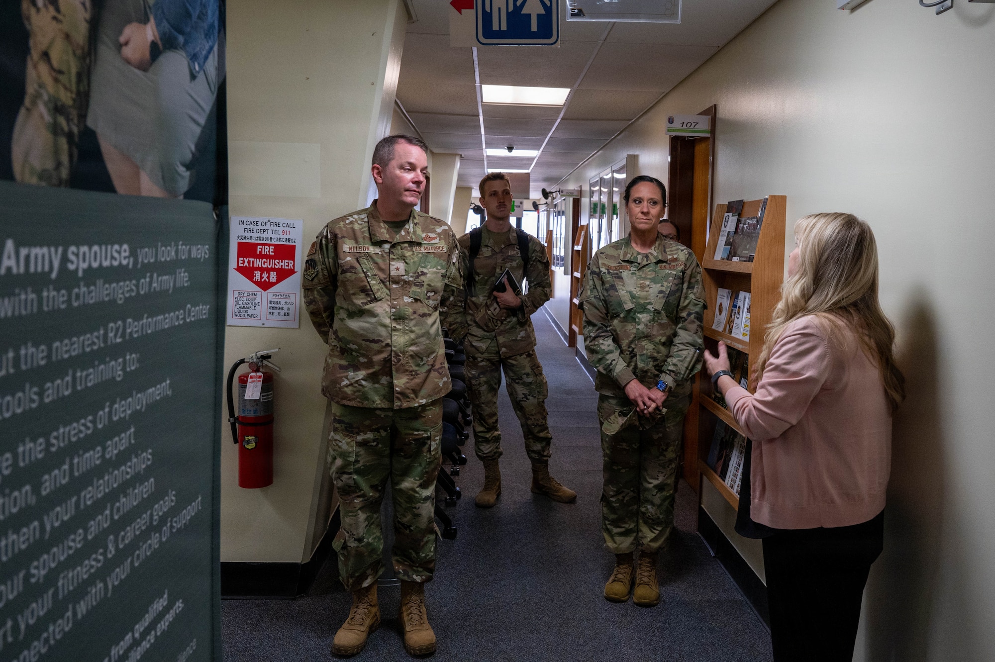 Civilian gives service members tour of building.