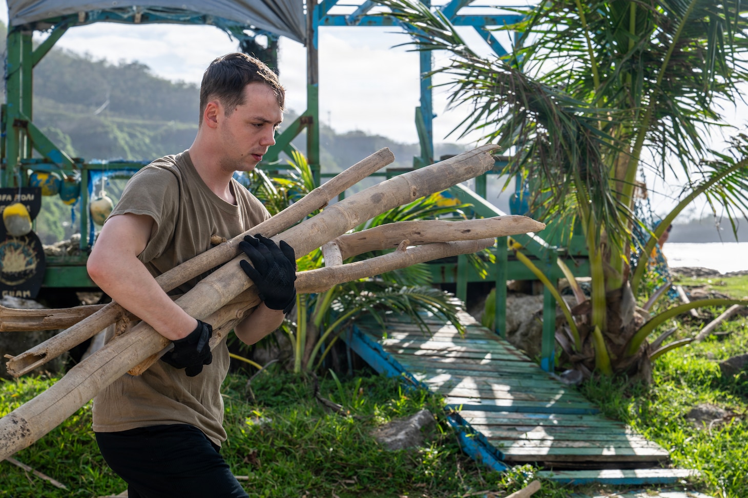 Cryptologic Technician (Maintenance) 1st Class Gabriel Roberts, assigned to Commander, Submarine Squadron 15 (CSS-15), participates in a beach cleanup following Super Typhoon Sinlaku. CSS-15 and other military commands across Guam are providing vital support to villages and civil authorities, strengthening crisis response and recovery efforts in the wake of Super Typhoon Sinlaku. (U.S. Navy photo by Mass Communication Specialist 1st Class Bryan Mai)