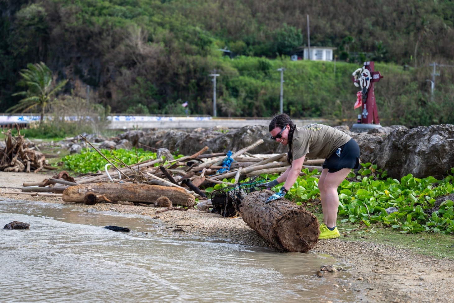 Legalman 1st Class Audrey Platz, assigned to Commander, Submarine Squadron 15 (CSS-15), participates in a beach cleanup following Super Typhoon Sinlaku. CSS-15 and other military commands across Guam are providing vital support to villages and civil authorities, strengthening crisis response and recovery efforts in the wake of Super Typhoon Sinlaku. (U.S. Navy photo by Mass Communication Specialist 1st Class Bryan Mai)