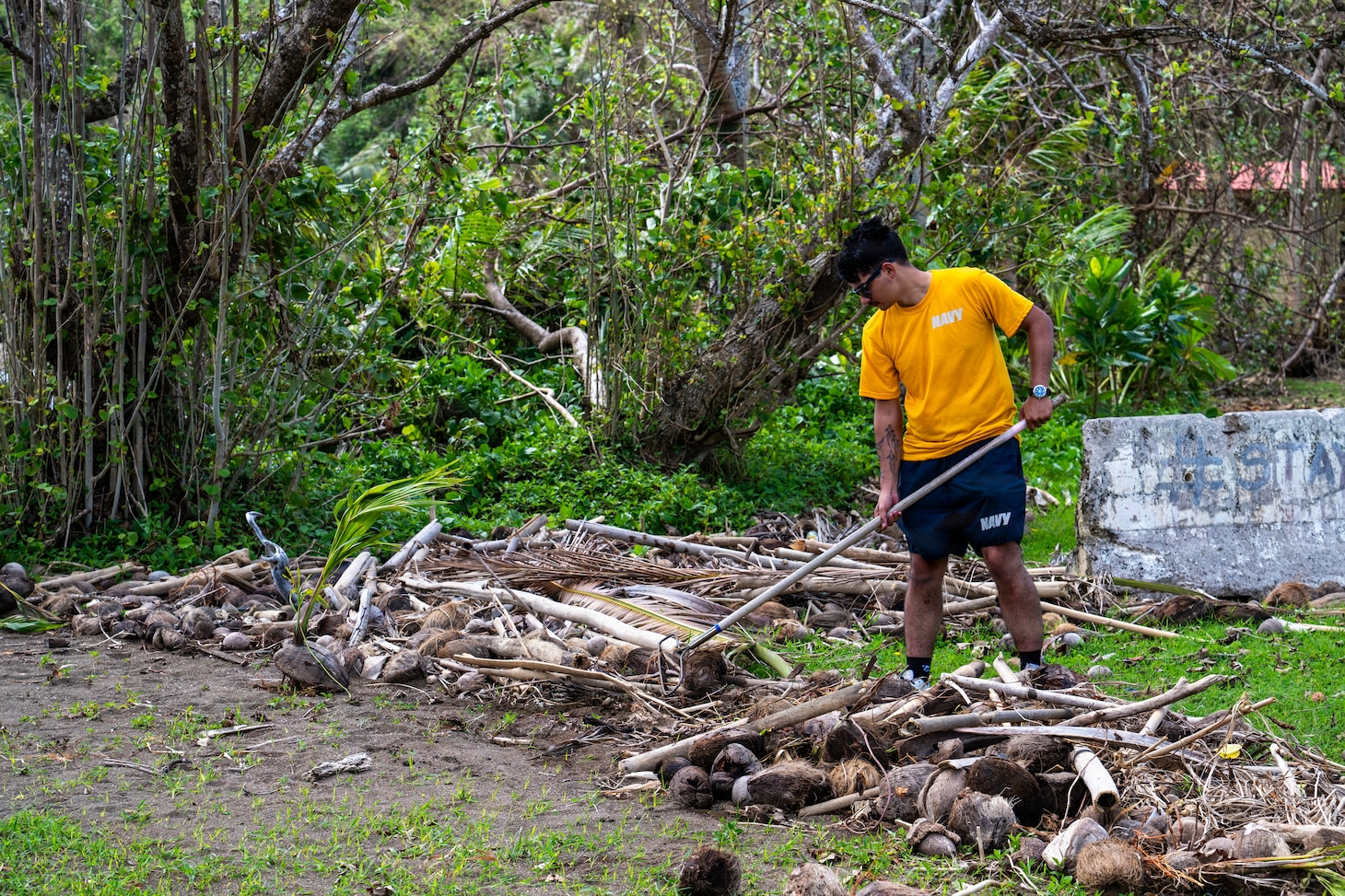 A Sailor assigned to Commander, Submarine Squadron 15 (CSS-15), participates in a beach cleanup following Super Typhoon Sinlaku. CSS-15 and other military commands across Guam are providing vital support to villages and civil authorities, strengthening crisis response and recovery efforts in the wake of Super Typhoon Sinlaku. (U.S. Navy photo by Mass Communication Specialist 1st Class Bryan Mai)