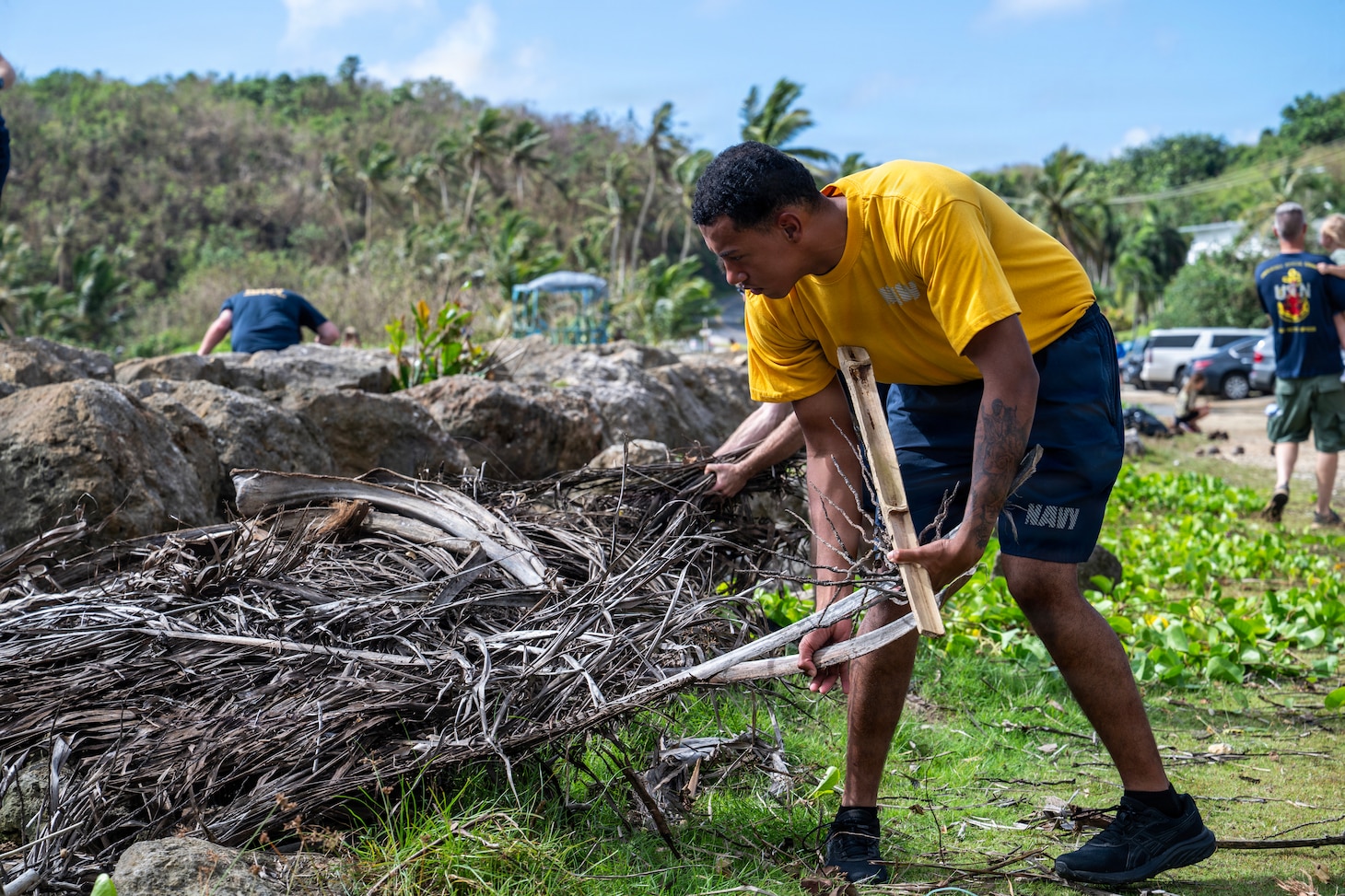 A Sailor assigned to Commander, Submarine Squadron 15 (CSS-15), participates in a beach cleanup following Super Typhoon Sinlaku. CSS-15 and other military commands across Guam are providing vital support to villages and civil authorities, strengthening crisis response and recovery efforts in the wake of Super Typhoon Sinlaku. (U.S. Navy photo by Mass Communication Specialist 1st Class Bryan Mai)