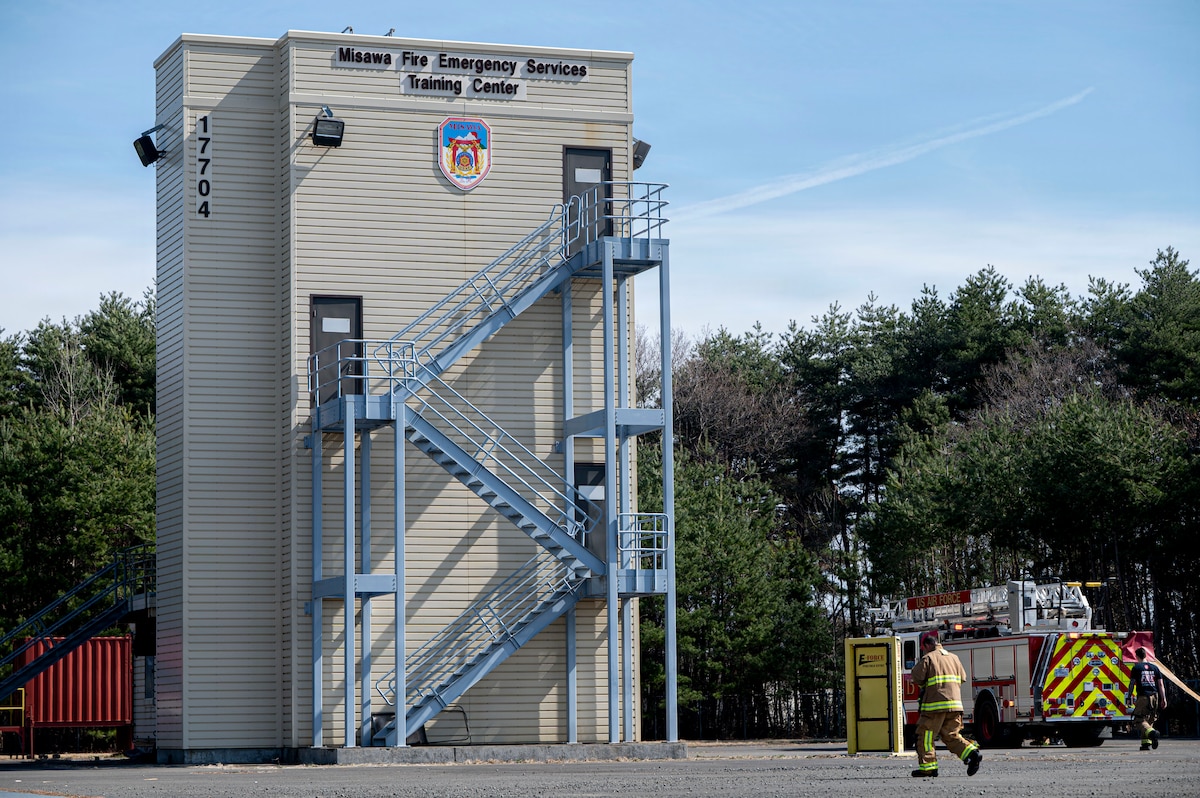 Firefighters from the U.S. Air Force firefighters assigned to the 35th Civil Engineer Squadron and Japan Air Self-Defense Force firefighters assigned to the 3rd Air Wing Fire and Rescue Flight conduct a bilateral firefighter exchange at Misawa Air Base, Japan, April 8, 2026. The building serves as an indoor simulator to practice emergency response procedures.(U.S. Air Force photo by Senior Airman Gavin Hameed)