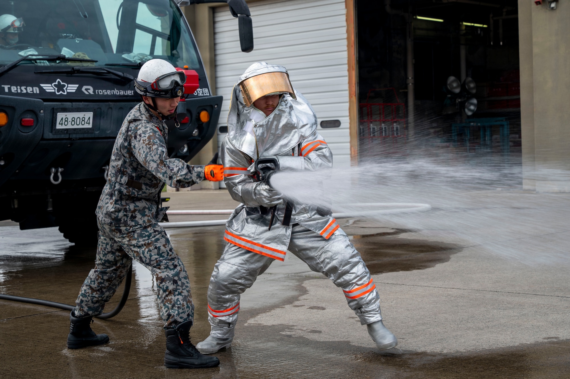 Firefighters from the U.S. Air Force 35th Civil Engineer Squadron and Japan Air Self-Defense Force 3rd Air Wing firefighters conduct a bilateral firefighter exchange at Misawa Air Base, Japan, April 8, 2026. The exchange gave participants firsthand experience learning about each other’s procedures and equipment while strengthening interoperability between the two units.(U.S. Air Force photo by Senior Airman Gavin Hameed)