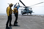 U.S. Navy Aviation Boatswain’s Mate (Handling) Airman Gregory Byias, assigned to San Antonio-class amphibious transport dock ship USS Portland (LPD 27), signals a CH-53E Super Stallion assigned to Marine Medium Tiltrotor Squadron (VMM) 163 (Reinforced), 11th Marine Expeditionary Unit, to takeoff in the Pacific Ocean, April 18, 2026.