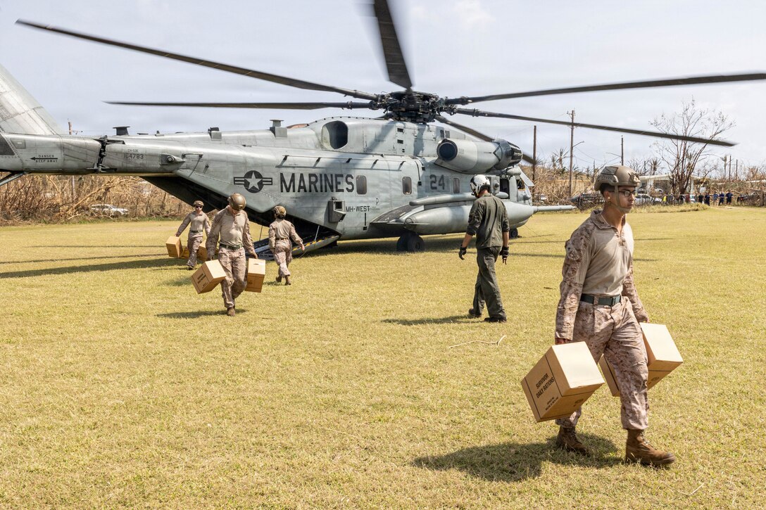 U.S. Marines with Combat Logistic Battalion 11, 11th Marine Expeditionary Unit, and Marine Medium Tiltrotor Squadron (VMM) 163 (Reinforced), 11th MEU, deliver meal kits to the people of the island of Saipan, April 18, 2026. The 11th MEU, embarked aboard the Boxer Amphibious Ready Group, is providing vital defense support to civil authorities, contributing to crisis response and recovery efforts in the wake of Super Typhoon Sinlaku. In supporting FEMA and local governments, the 11th MEU fills critical capability gaps to enable restoration of essential services by civil authorities. (U.S. Marine Corps photo by Cpl. Avery Wayland)