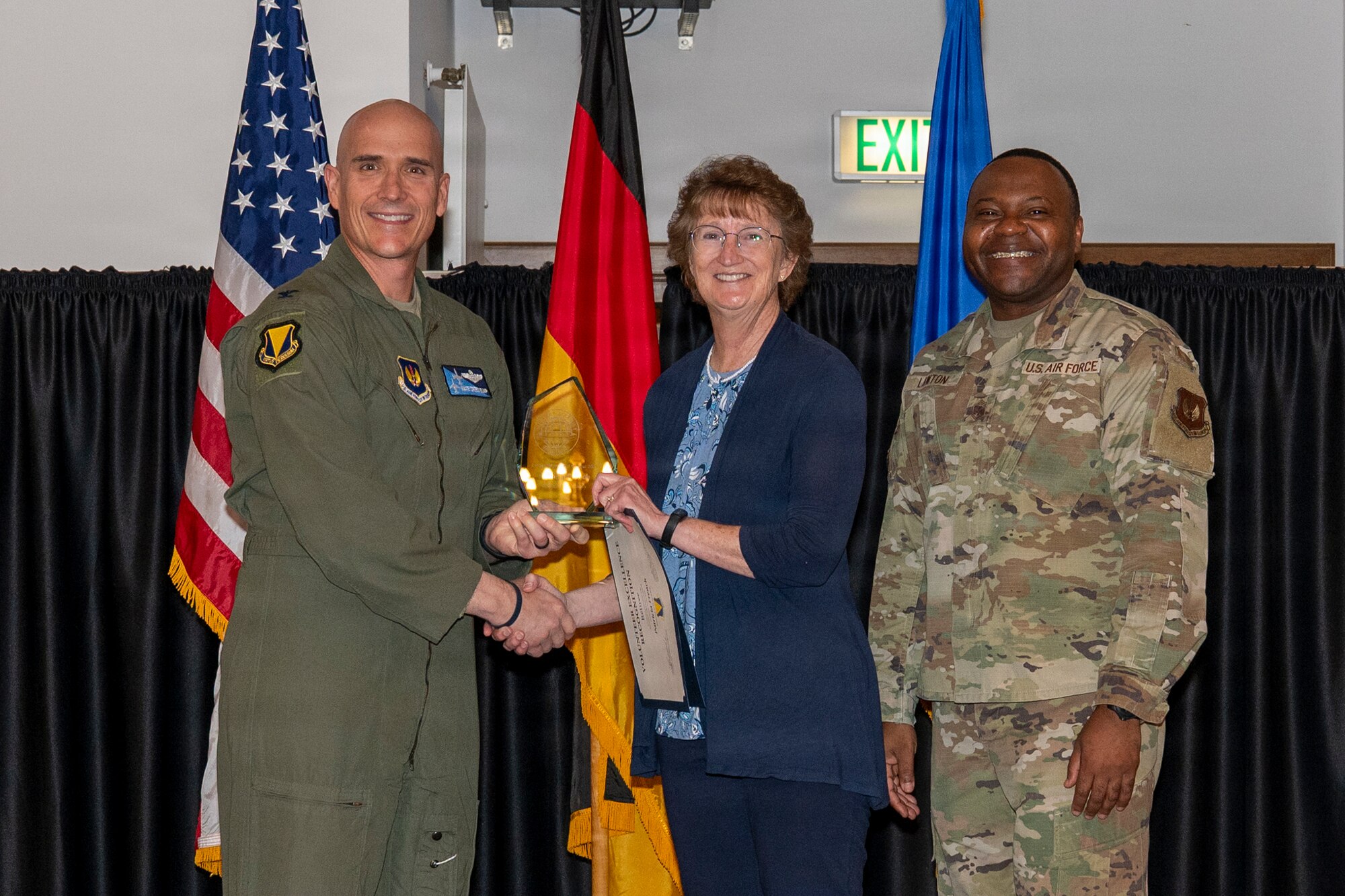 U.S. Air Force Col. Nathan Bump, 86th Airlift Wing deputy commander, presents a Volunteer Excellence Award to Patricia French, retiree category winner, at Ramstein Air Base, Germany, April 24, 2026.