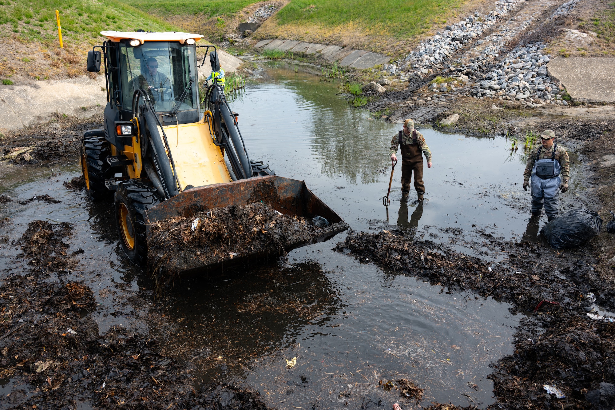 Airmen removed buildup from a drainage outfall to keep water moving and reduce pollution. Small actions like these play a direct role in protecting the environment and supporting the surrounding community.