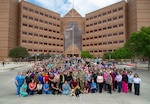 Staff members from Brooke Army Medical Center gather for a group photo on April 16, 2026, in front of the hospital to commemorate the 30th anniversary of the current BAMC facility. The medical center officially opened April 13, 1996, following the transfer of patients from the original hospital, continuing a legacy of military medicine in San Antonio that dates back to 1879. Today, BAMC remains a premier military treatment facility, delivering high-quality care while supporting the readiness of service members, their families, beneficiaries, and retirees. (DoW photo by Jason W. Edwards)