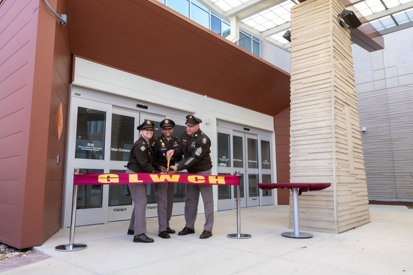 An image of a group of soldiers cutting Ribbon in front of a building