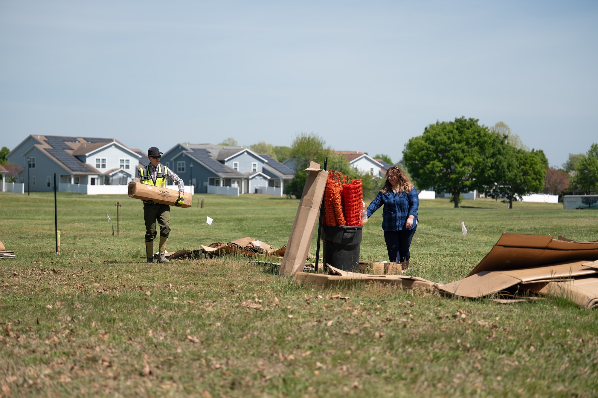 Team Dover Airmen are laying the groundwork for a future pollinator garden by covering an area on base with cardboard and weed-barrier fabric to prevent unwanted growth before planting begins. This process helps eliminate plant competition, allowing pollinator-friendly plants the best chance to thrive.