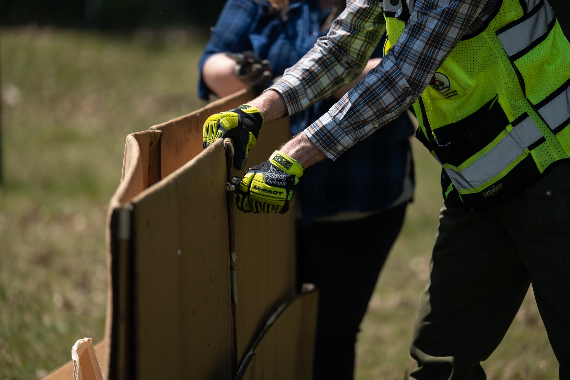 Team Dover Airmen are laying the groundwork for a future pollinator garden by covering an area on base with cardboard and weed-barrier fabric to prevent unwanted growth before planting begins. This process helps eliminate plant competition, allowing pollinator-friendly plants the best chance to thrive.