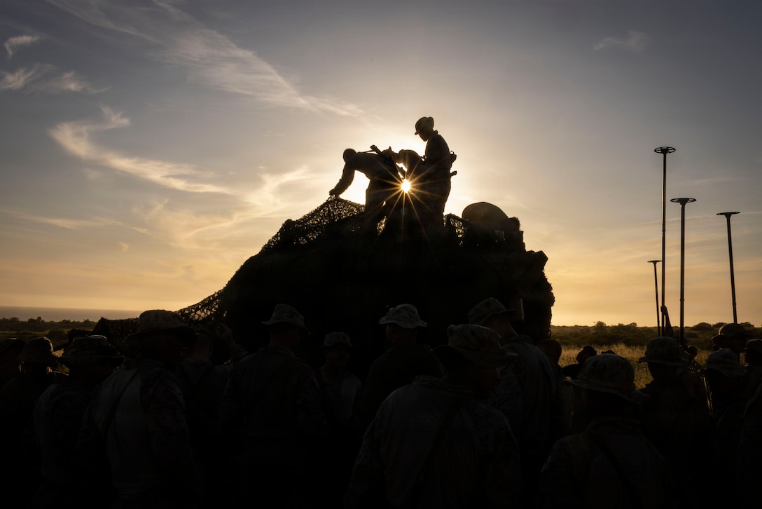 U.S. Marines assigned to Battalion Landing Team 2/4, 13th Marine Expeditionary Unit, conceal an amphibious combat vehicle with camouflage netting during ACV integration training at Marine Corps Base Camp Pendleton, California, April 15, 2026. ACV integration training increases BLT 2/4’s combat readiness by fully certifying and preparing Marines to safely execute amphibious operations in support of the 13th MEU. (U.S. Marine Corps photo by Cpl. Mary R. Jenni)