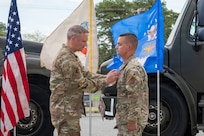 U.S. Air Force Master Sgt. Charles Zingrone, 177th Fighter Wing Logistics Readiness Squadron Petroleum, Oils and Lubricants fuels management flight chief, receives a Bronze Star medal from Col. Matthew Vanderschuere, 177th Fighter Wing Mission Support Group commander, during a presentation ceremony for Zingrone at the 177th Petroleum, Oils and Lubricants facility, Egg Harbor Township, New Jersey, April 17, 2026.