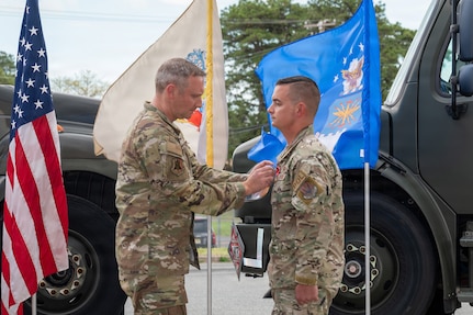 U.S. Air Force Master Sgt. Charles Zingrone, 177th Fighter Wing Logistics Readiness Squadron Petroleum, Oils and Lubricants fuels management flight chief, receives a Bronze Star medal from Col. Matthew Vanderschuere, 177th Fighter Wing Mission Support Group commander, during a presentation ceremony for Zingrone at the 177th Petroleum, Oils and Lubricants facility, Egg Harbor Township, New Jersey, April 17, 2026.